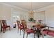 Formal dining room with classic wood furniture, chandelier lighting, and elegant wainscoting at 3130 Caney Creek Ln, Cumming, GA 30041