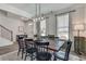 Dining room with farmhouse table and black chairs, view of entryway at 3346 Long Creek Dr, Buford, GA 30519