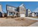 Two-story home with gray siding, brick accents, and a two-car garage at 3346 Long Creek Dr, Buford, GA 30519