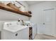 Convenient laundry room with washer, dryer, and additional shelving at 3346 Long Creek Dr, Buford, GA 30519