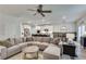 Relaxing living room featuring a large sectional sofa and ceiling fan at 3346 Long Creek Dr, Buford, GA 30519