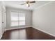 Well-lit bedroom with a large window and ceiling fan at 730 Lake Forest Pass, Roswell, GA 30076