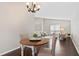 Bright dining area with wooden table and chairs, open to living room at 730 Lake Forest Pass, Roswell, GA 30076