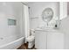 Bright bathroom featuring white tiling, shower and tub combo, and updated sink and vanity at 75 Boulevard Ne # 1, Atlanta, GA 30312