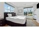 Sunlit bedroom features city views, hard wood floors, and accent rug at 75 Boulevard Ne # 1, Atlanta, GA 30312