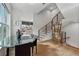 Elegant dining area with a glass table, modern staircase, and hardwood floors at 75 Boulevard Ne # 1, Atlanta, GA 30312