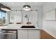 Close-up of modern kitchen island with sink, stainless steel dishwasher, and pendant lighting at 75 Boulevard Ne # 1, Atlanta, GA 30312