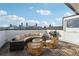 Stunning rooftop deck with outdoor seating, a grill, a fire pit, and city views of the downtown skyline at 75 Boulevard Ne # 1, Atlanta, GA 30312