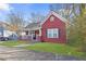 Red house with front porch and well-maintained lawn at 1081 Longley Nw Ave, Atlanta, GA 30318