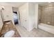Well-lit bathroom featuring double sinks, a shower over bath, and tile flooring at 2781 Interlaken Dr, Marietta, GA 30062