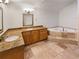 Bathroom with double vanity, soaking tub, and granite countertops at 2781 Interlaken Dr, Marietta, GA 30062