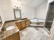 Elegant bathroom with dual sinks, granite counters, a jacuzzi tub, and a glass-enclosed shower at 2781 Interlaken Dr, Marietta, GA 30062