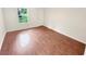 Bedroom with gleaming hardwood floors and a large window offers a bright and inviting space at 2781 Interlaken Dr, Marietta, GA 30062
