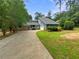 Charming home with a stone facade and siding and an attached two-car garage on a tree-lined lot at 2781 Interlaken Dr, Marietta, GA 30062