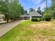 Charming home with a stone facade and siding and an attached two-car garage on a tree-lined lot at 2781 Interlaken Dr, Marietta, GA 30062