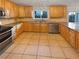 Kitchen with light wood cabinets, granite countertops, and tile floors at 2781 Interlaken Dr, Marietta, GA 30062