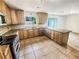 Well-lit kitchen featuring wooden cabinets, granite countertops, and stainless steel appliances at 2781 Interlaken Dr, Marietta, GA 30062