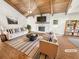 Bright living room featuring vaulted wood ceilings, stone fireplace and hearth, and stylish furniture at 2781 Interlaken Dr, Marietta, GA 30062