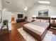 Virtually staged main bedroom with hardwood floors and an en-suite bathroom at 2781 Interlaken Dr, Marietta, GA 30062