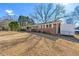 Side view of brick ranch house and yard at 4443 Maroney Mill Rd, Douglasville, GA 30134