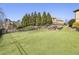 Well-manicured backyard featuring a lush lawn, landscaping, and privacy trees at 4532 Summersweet Dr, Marietta, GA 30066