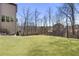 Spacious backyard featuring manicured lawn, a fence, and mature trees offering privacy at 4532 Summersweet Dr, Marietta, GA 30066