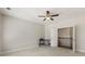 Neutral bedroom with a ceiling fan, a desk, and access to the upper level at 4532 Summersweet Dr, Marietta, GA 30066