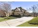 Beautiful brick home with a three-car garage, mature landscaping, and a paved driveway at 4532 Summersweet Dr, Marietta, GA 30066
