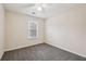 Spacious bedroom with gray carpet and a window with blinds at 1025 Rock Creek Ln, Norcross, GA 30093