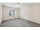 Spacious bedroom with ceiling fan and grey carpeting at 1025 Rock Creek Ln, Norcross, GA 30093