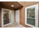 Exterior view of townhouse with sliding glass door, white door, and window at 1025 Rock Creek Ln, Norcross, GA 30093