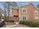 Tan two-story home with brick accents and wooden fence at 1025 Rock Creek Ln, Norcross, GA 30093