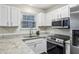 Modern kitchen with granite countertops and stainless steel appliances at 1025 Rock Creek Ln, Norcross, GA 30093