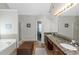 Double vanity bathroom with granite countertop and garden tub at 1912 Wheat Valley Cir, Conyers, GA 30013