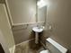 Basement bathroom with pedestal sink and shower at 5226 Oaktree Trl, Lithonia, GA 30038