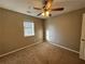 Bright bedroom with ceiling fan and neutral carpeting at 5226 Oaktree Trl, Lithonia, GA 30038