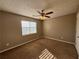 Bright bedroom with ceiling fan and large window at 5226 Oaktree Trl, Lithonia, GA 30038