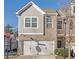 Two-story townhome with gray siding, brick accents, and a two-car garage at , Stone Mountain, GA 30083