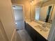 Double sink bathroom with dark vanity and a large mirror at 300 River Birch Ct, Canton, GA 30114