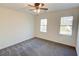 Bright bedroom with ceiling fan, carpet, and two windows at 1080 Willow Bnd, Roswell, GA 30075