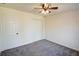 Bright bedroom with ceiling fan, carpet, and door at 1080 Willow Bnd, Roswell, GA 30075