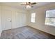 Bright bedroom with ceiling fan, carpet, and two windows at 1080 Willow Bnd, Roswell, GA 30075