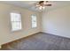 Bright bedroom with ceiling fan, carpet, and two windows at 1080 Willow Bnd, Roswell, GA 30075