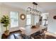 Sunlit dining room features hardwood floors, a large table, and stylish decor at 1080 Willow Bnd, Roswell, GA 30075