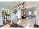 Elegant dining room with a light wood table, modern chairs, and a stylish light fixture at 1080 Willow Bnd, Roswell, GA 30075