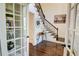 Bright entry with hardwood floors, built-in shelving, and elegant staircase at 1080 Willow Bnd, Roswell, GA 30075