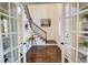 Bright entry with hardwood floors, built-in shelving, and elegant staircase at 1080 Willow Bnd, Roswell, GA 30075