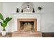 Brick fireplace with white mantel and decorative mirror at 1080 Willow Bnd, Roswell, GA 30075