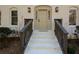 Front entrance with a taupe door, dark brown railings, and white brick steps at 1080 Willow Bnd, Roswell, GA 30075