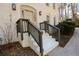 Front entrance with a taupe door, dark brown railings, and white brick steps at 1080 Willow Bnd, Roswell, GA 30075